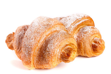 two croissant sprinkled with powdered sugar isolated on a white background closeup