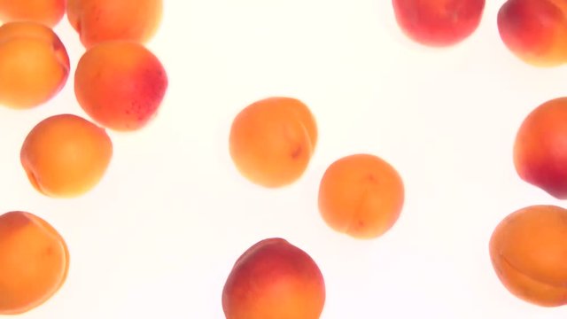 Apricot. Ripe Organic Apricots are rolling on the table. Slow motion 240 fps. Full HD 1080p. 