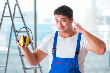 Worker with noise cancelling headphones
