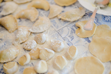 Fototapeta na wymiar Closeup view of making traditional dumplings on kitchen table background