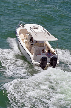 Angled Overhead View Of A Sport Fishing Boat Cruising On The Florida Intra-coastal Waterway Off Miami Beach.