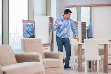 Young man shopping in furniture store