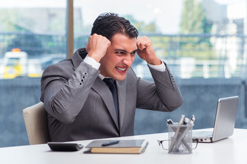 Busy angry businessman with heaps of paper