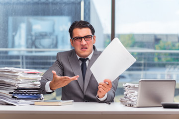 Fototapeta premium Angry businessman with too much work in office