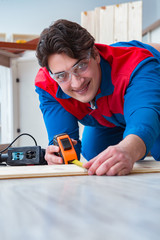 Young carpenter working with wooden planks