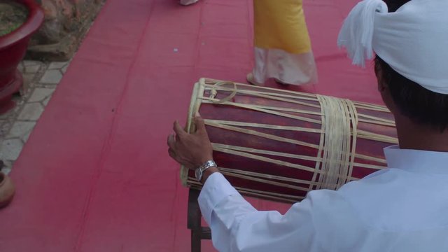 National vietnamese dance tourist show at Po Nagar Cham Towers. Man in traditional costume plays on a drum,
