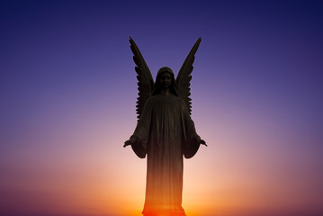 Beautiful angel in heaven over bright sunset