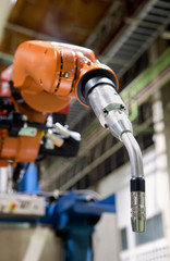 Closeup robot welding arm in factory