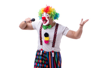 Funny clown with a microphone singing karaoke isolated on white 