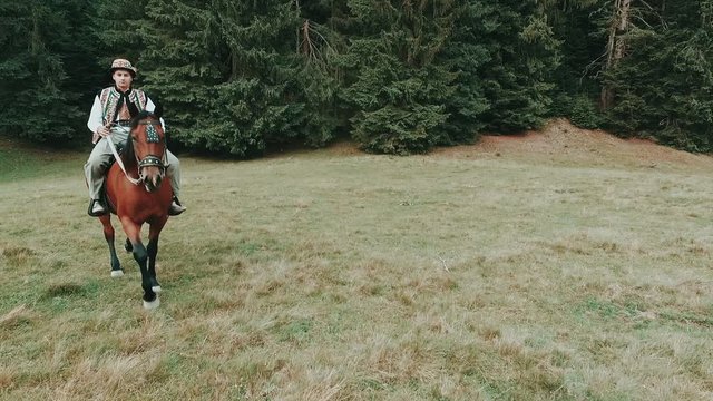 Man rides horse. National clothes. Slow motion
