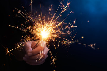 Close up of hand holding a sparkler