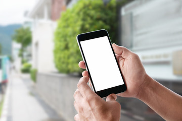 Man's hand using cellphone outdoor, Man typing text message on smart phone blurred city background