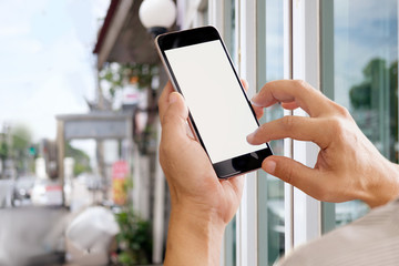 Man's hand using mobile phone outdoor, Man typing text message on smartphone blurred city background