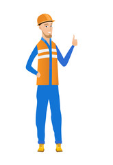 Young caucasian builder giving thumb up.