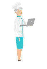 Seinor caucasian chef cook using a laptop.