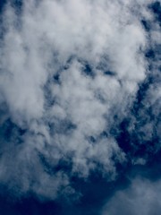 Thin white clouds in blue sky