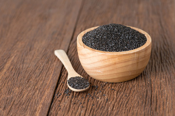 Basil seeds in wood bowl.