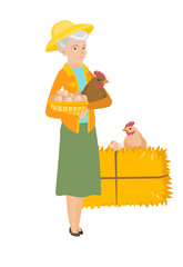 Senior farmer holding chicken and basket of eggs.
