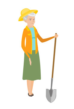Senior caucasian farmer holding a shovel.
