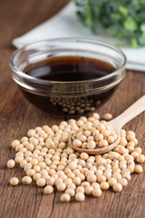 Soy bean with soy sauce on wood table.