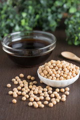 Soy bean with soy sauce on wood table.
