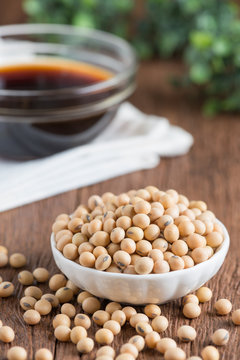 Soy bean with soy sauce on wood table.
