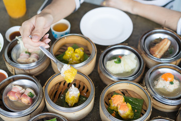 Women's hand hold dim sum. Selective focus.