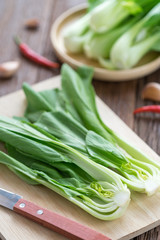 Bok choy (chinese cabbage) on wooden board.