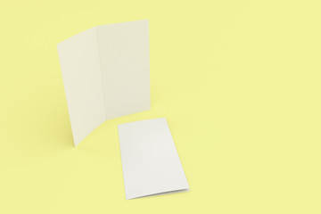 Obraz na płótnie Canvas Blank white two fold brochure mockup on yellow background