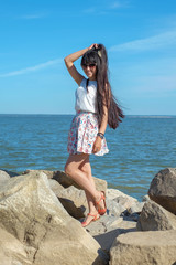 Fototapeta na wymiar Beautiful young woman on a sea-shore