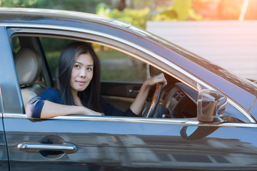 Asian woman driving her car.