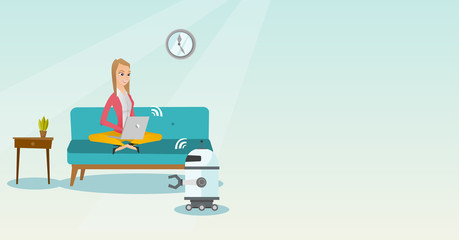 Young caucasian engineer programming a robot.