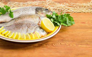 Carp and crucians prepared for cooking on dish