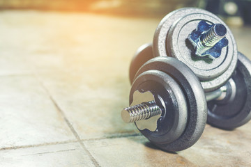Twin Iron Dumbbells on the floor for home workout.