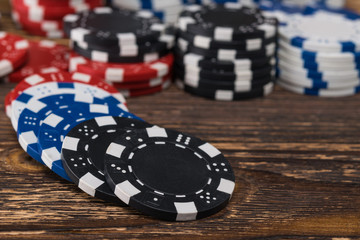 Poker chips scattered on the background of a wooden table