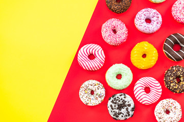 Colorful donuts border background, from above