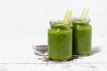 healthy green fruit and vegetable smoothies with chia seeds in jars