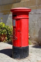 Fototapeta na wymiar Traditional red British post box, Vittoriosa, Malta.