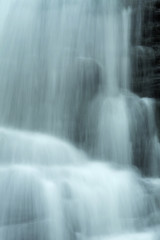 Fototapeta na wymiar Rushing water within Carpenter's Falls in Granby, Connecticut.