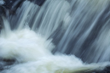 Fototapeta na wymiar Rushing water at base of Carpenter's Falls in Granby, Connecticut.
