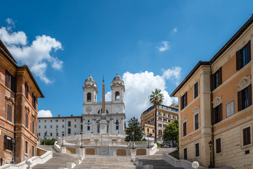 Fototapeta na wymiar Piazza di Spagna and spanish steps to Piazza della Trinita dei Monti with no people a sunny summer day