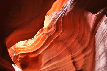 Nature red sandstone textured background. Swirls of old red  sandstone wall abstract pattern in Lower Antelope Canyon, Page, Arizona, USA.