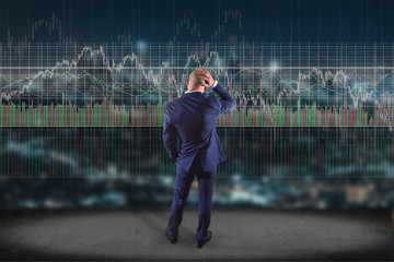 Man in front of a wall writing on a stock exchange interface - tradex concept