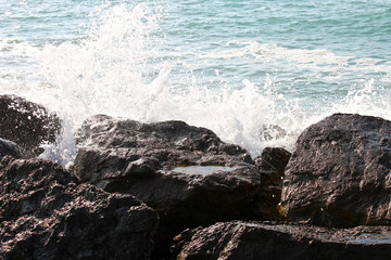 Water splashing in the rocks in Benicassim, a beach resort in the Costa del Azahar coast, province of Castello, Spain