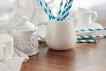 Set of white empty tableware with striped tubules