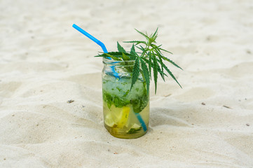 Mojito drink with leafs of marijuana plant