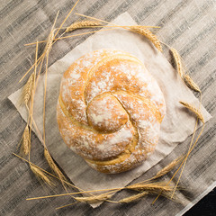 still life with delicious baked good on a light textile background. Flat lay, capital bun