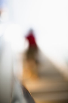 Defocused Image Of Person Walking On Steps