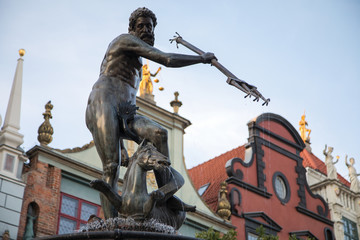 Fountain of the Neptune and colorful gothic houses in old town of Gdansk, Poland. View on the famous Neptune fountain in the center of the town. Gdansk is the historical capital of Polish Pomerania. © AnnaRudnitskaya