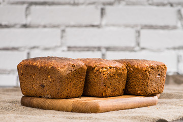 homemade rustic rye breads with seeds on a wooden cutting board, selective focus, rustic style